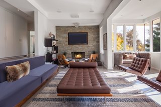 The sunken living room leads to a large outdoor deck.