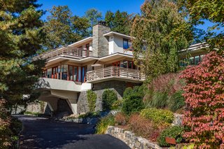 The home sits on a .65-acre hilltop site with fantastic views and beautiful landscaping, including mature oaks, maple, elm trees, Japanese maples, and magnolias.