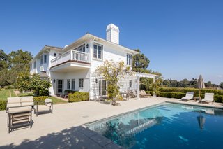 The outdoor space features mature trees, gardens, a serene swimming pool, and views from downtown all the way out to the Pacific Ocean.