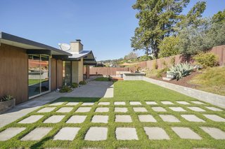 The landscaped backyard comes with programmable irrigation and plenty of room for entertaining. 