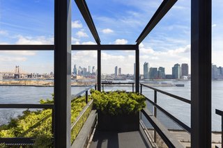 The "steel-framed cage of balconies" frames the skyline. 