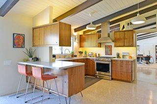 The kitchen updates remain true to the home’s midcentury character. Terrazzo tiles are used throughout the home. 