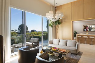 Glass sliding doors lead to an outdoor terrace with sweeping city views.