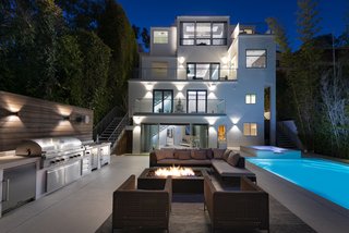 The home at night. Note the high privacy hedges that rim the outdoor space. 