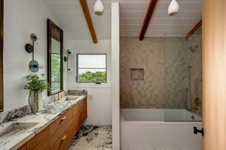 The principal bath has been updated with an elegant mix of materials and a deep soaking tub.&nbsp;