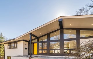 The glazed facade is broken up by classic midcentury lines.