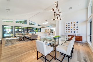 The main living space features a 12.5' vaulted ceiling. The branched chandelier above the dining table is from France &amp; Son.
