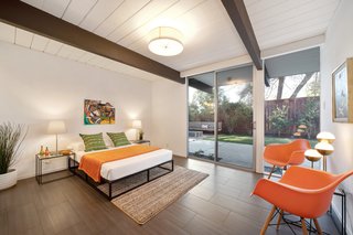The master bedroom enjoys lots of natural light thanks to sliding doors which lead out to the backyard.
