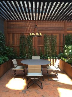 The ivy-covered terrace has three access points from inside the apartment. 