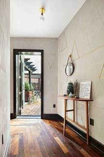 The wall finish in the foyer leading to the terrace is custom-crafted plasterwork from Surface & Architecture and Workshop.