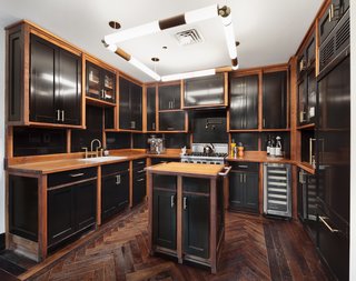 The customized kitchen opens to the dining area where floor-to-ceiling French doors lead out to the terrace. 