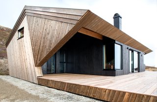 The "hooded" roof, originally designed as a protective feature against the risk of avalanches, shields the front and rear facades.