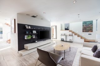 The light-filled, open-plan living and entertaining spaces feature double-height ceilings and a variety of bespoke built-ins.&nbsp;