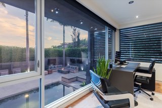 The home office overlooks the pool.&nbsp;