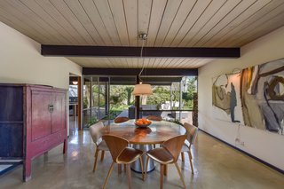 The dining room connects with the living space and leads to the outdoors.