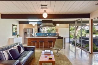 The kitchen overlooks a sitting room, which is perfectly appointed for hosting and indoor/outdoor entertaining.