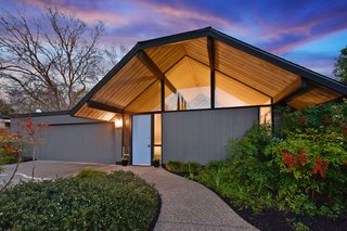 The distinctive facade references a traditional thatched English cottage. 