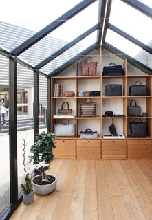 The Alpine Lodge by WANT Les Essentiels de la Vie - Photo 6 of 7 - The structure features custom millwork to display the brand's bags and accessories. 