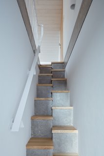 Old and new merged in the design of Village House. During building, ORA and their collaborative team opted for using conventional cellular concrete blocks for the walls and staircase.