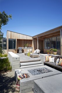 This house creates an indoor/outdoor retreat to share with extended family and friends. The house forms a courtyard to the south that captures the sun and blocks the wind. 