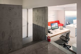 Stairs leading to the garden-level suite are separated by a glass partition and pocket door.