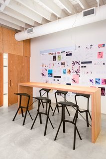 The Douglas fir plywood bar table by Nico Spacecraft is flanked by Miura stools by Konstantin Grcic. 