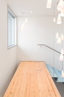 A fir walkway at the top of the stairs leads to the boardroom.