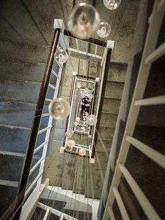 120 glass pendants from Bocci’s 14-series illuminate the back staircase.