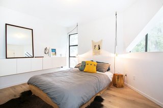 The angular master bedroom has floating cupboards and ample daylight.