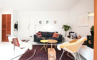 White floors and walls serve as a gallery backdrop for the couple's colourful art and furniture collections.