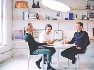 Heintzman, Davis and Peet sit beneath a Button light in the ANDlight studio. All ANDlight products are designed and hand-assembled in their industrial Vancouver workspace, originally built as a stable in the early century.