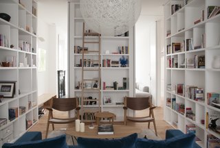 Top 5 Homes of the Week With Libraries We Love - Photo 4 of 5 - A central volume of storage loosely divides the ground-floor living space into two zones, while doors concealed in this and other adjacent volumes allow the space to be separated into two rooms.