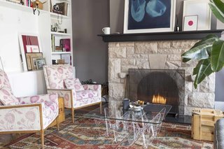 A fireplace anchors the couple's living room, which is adorned with modern artwork as well as beloved curios.