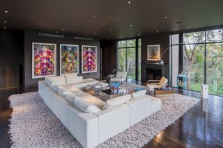 An Austin Airbnb Is a Blissful Getaway - Photo 3 of 7 - Elsewhere, color is conspicuous by its absence, like in the mostly monochromatic living area. Exhibition banners from the De Young museum in San Francisco hang on the far end of the room.