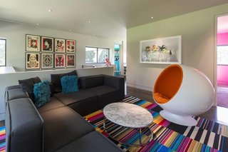 An Austin Airbnb Is a Blissful Getaway - Photo 5 of 7 - Rising along the staircase to the second-story is a wall of prints by Shapard Fairey. The pieces span more than a decade of the artist's career.