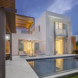 Open-corridor passageways, balconies, and overpasses designed by GM Architects, create a smooth integration between indoor and outdoor spaces at the Sofitel Tamuda Bay. 