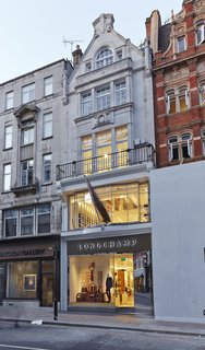 The modern window display glows against its 19th century exterior.