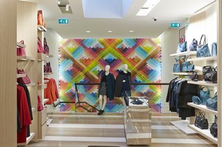 The prismatic hues of Maya Hayuk’s mural complement the hot and cool tones of the merchandise lining the walls. 