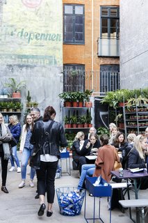 A plant shop occupies a section of the courtyard, where shop visitors can gather over coffee, pastries, ice cream, and more.