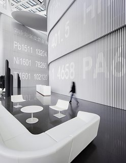 A ticker runs along the wall, superimposing digitally the work done in physical space.