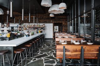 Vintage Northern European furniture, shelving, and pendant lights contribute to a rugged impression.