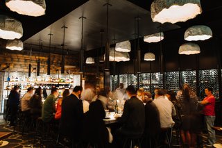 The custom steel wine wall is the seventh one to be installed at separate Barcelona Wine Bar & Restaurant locations in the last 10 years.