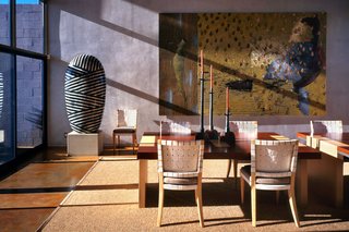 Lacewood and oak tables designed by Seattle’s Terry Hunziker dominate the dining area, and glass walls at the east and west provide passage to outdoor living spaces. 