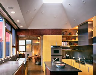 The kitchen features poured concrete counters, double convection ovens, and dual warming drawers and dishwashers.