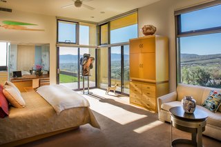 The master bedroom comes equipped with dual vanities, a steam shower, and a walk-in closet with its own patio. An adjacent study or exercise space and separate bath complete the suite. 