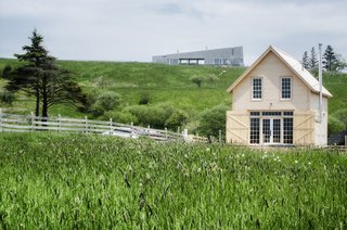 Clapboard siding and cedar shingles make up the exterior walls and roof while wide pine boards were used for the flooring and wainscoting. Original windows and restored wooden benches preserve the schoolhouse's character.