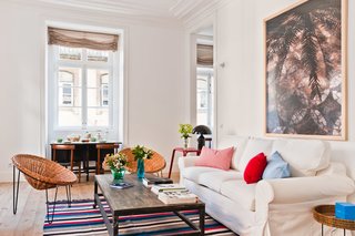 Baixa House Lets Travelers Be at Home in Lisbon - Photo 4 of 10 - A one-bedroom apartment, Estrela features garden furniture alongside pieces from the '50s and '60s. The coffee table can be wheeled aside to allow for the sofa bed to expand.