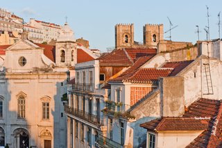 Baixa House Lets Travelers Be at Home in Lisbon - Photo 9 of 10 - From the main bedroom, guests can look out over the Baixa skyline, which features the Madalena church and the rooftops of Alfama and Se Cathedral.