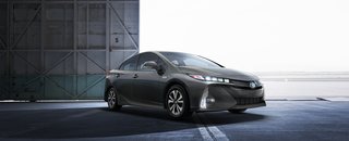 Prius Prime has a large acrylic grille that masks the radiator cooling openings; when cooling isn't necessary, a flap closes for better aerodynamics. The inspiration for the front view was Toyota's Mirai, creating a cohesive look across product lines.