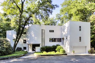 A Curvaceous Connecticut Home Asks $2.6M - Photo 1 of 8 - The entrance faces north and is approached by a drive through the ravine and adjacent woods.